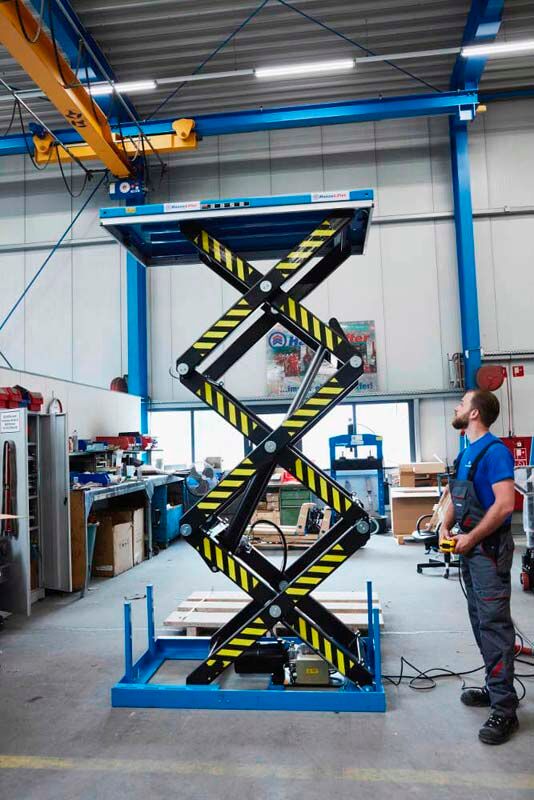 Scissor lift table - ADE-WERK - hydraulic / stationary / U-shape